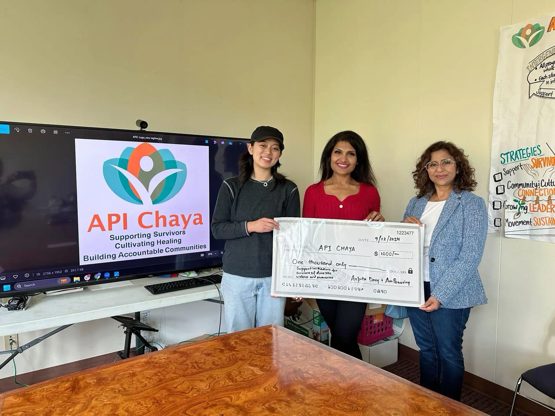 Titleholder presenting a donation to API Chaya
