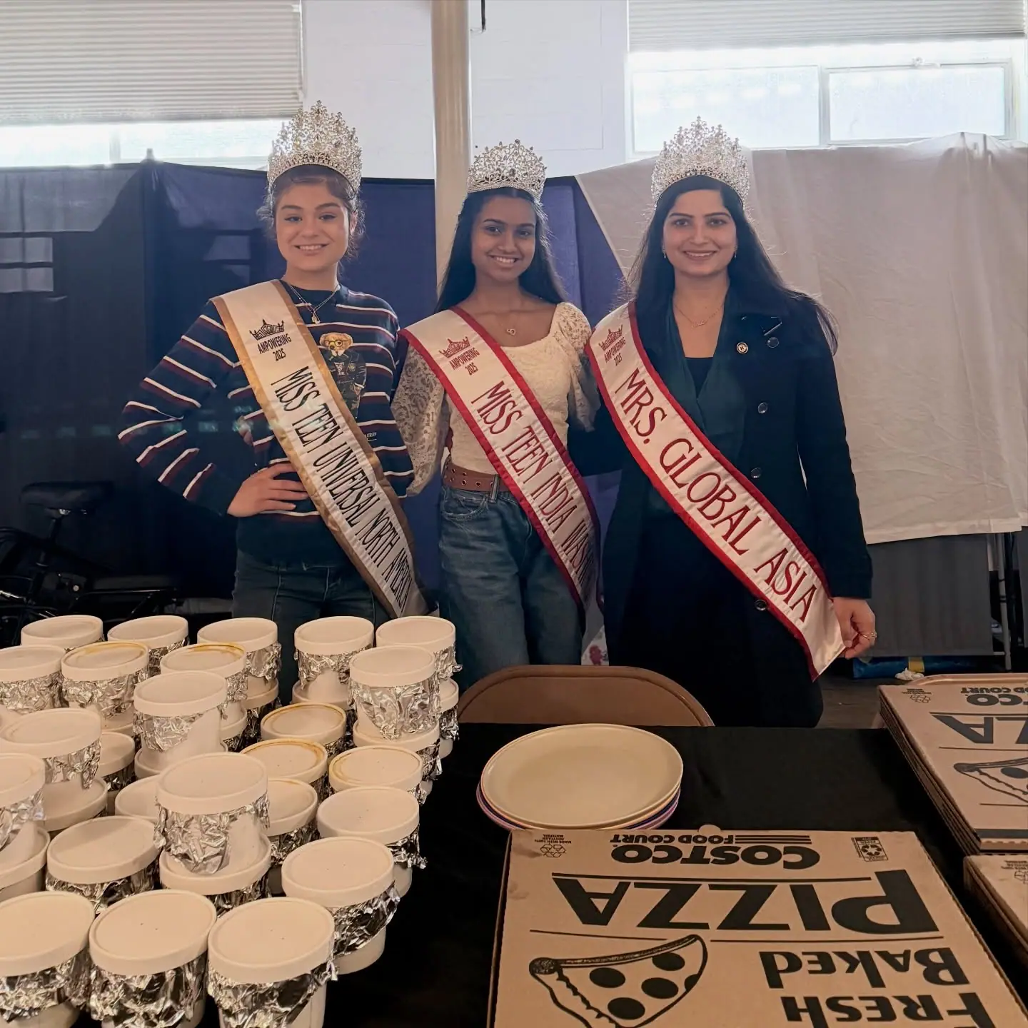 Three titleholders serving at a community meal