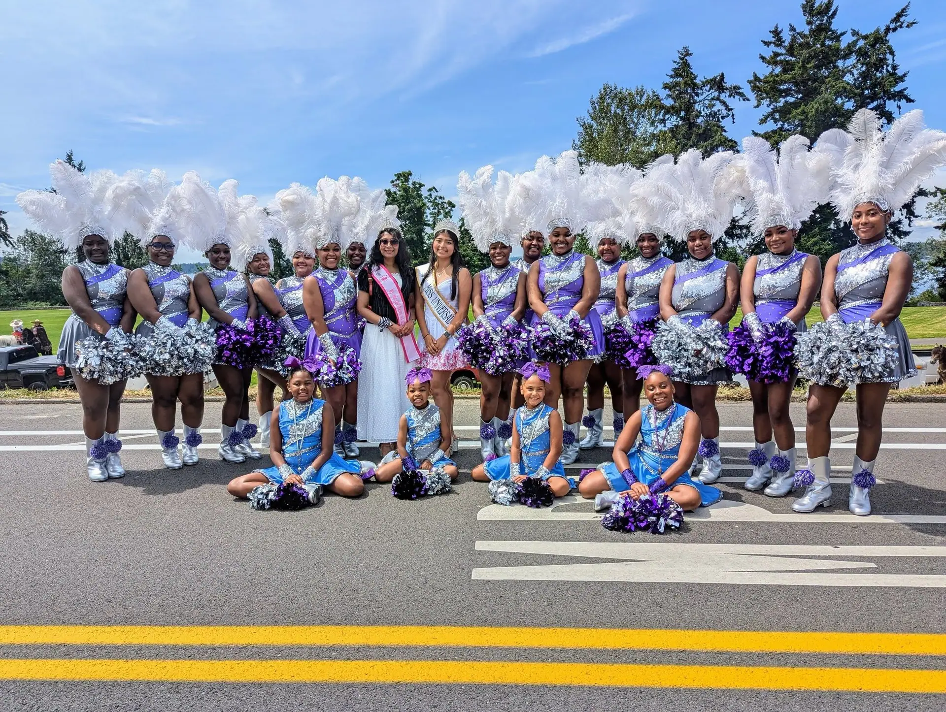 Titleholders with a drill team at a community parade