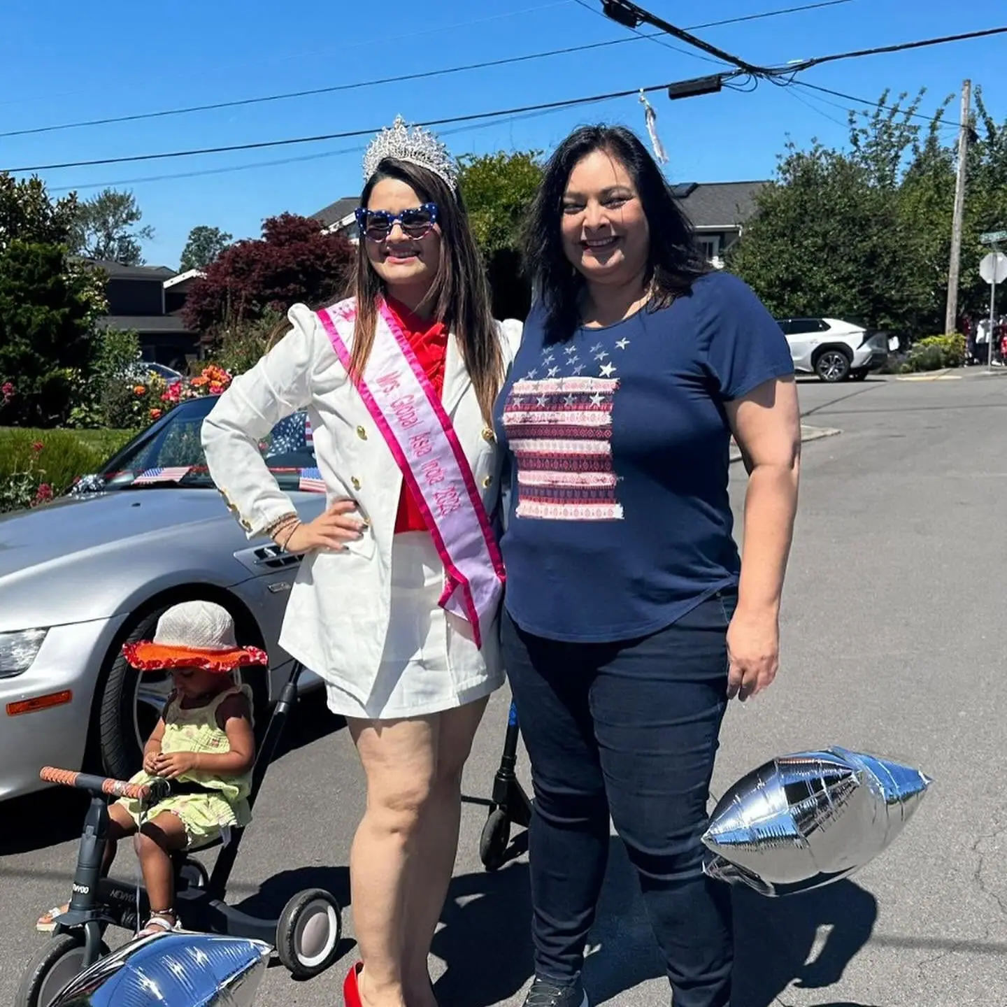 Mrs Global Asia India 2023 in her crown and sash with an AmPowering supporter on a sunny parade day