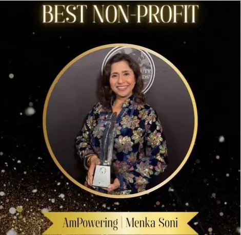 AmPowering President & Founder Menka Soni holding the Best Non-Profit award