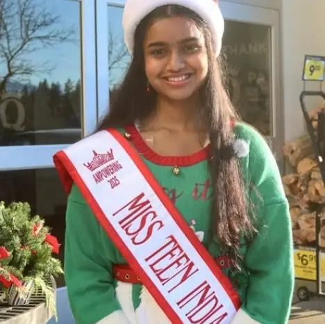 Miss Teen India Washington in a Santa hat at the KidVantage bell ringing