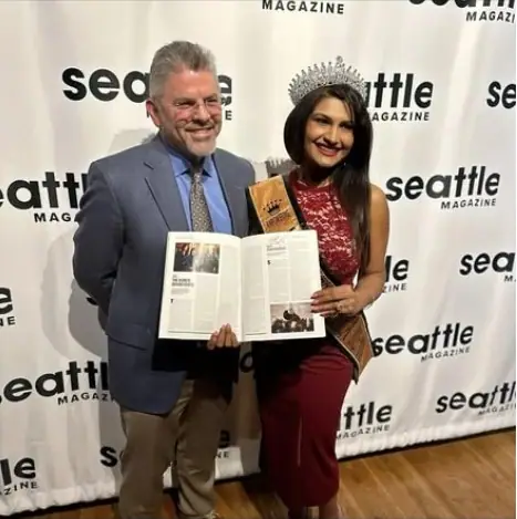 Mrs Universe America with a guest holding Seattle Magazine at the Most Influential People event