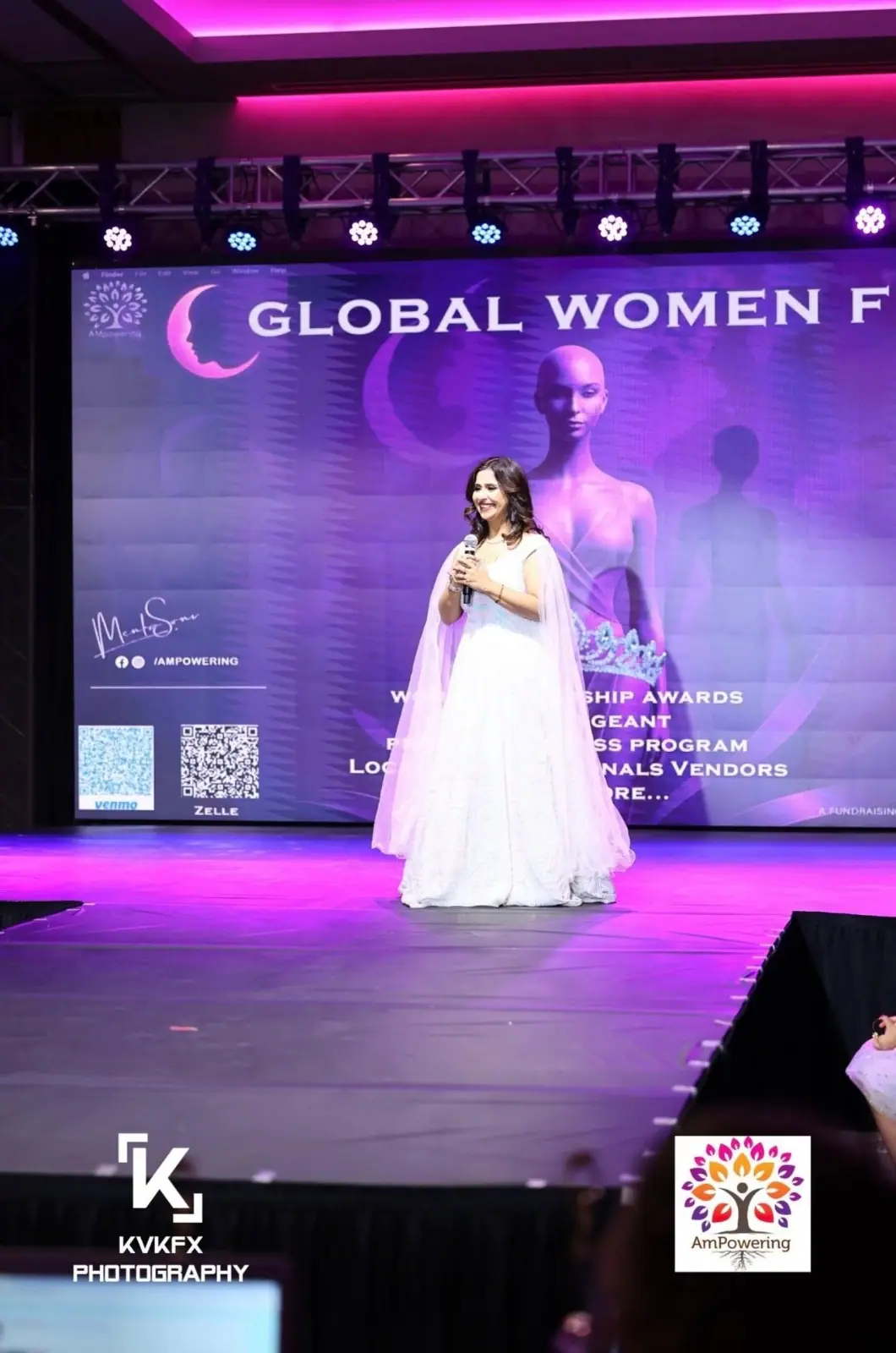The host on stage at the Global Women Festival, in front of the Women Leadership Awards screen
