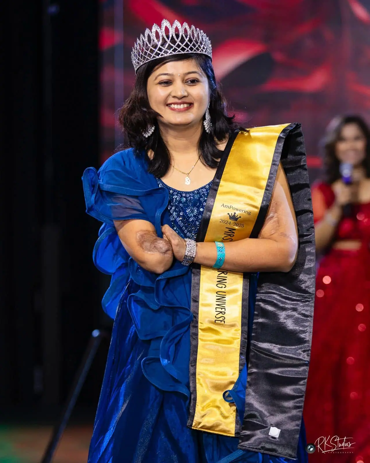 The 2024–2025 Mrs. Empowering Universe in her crown and sash