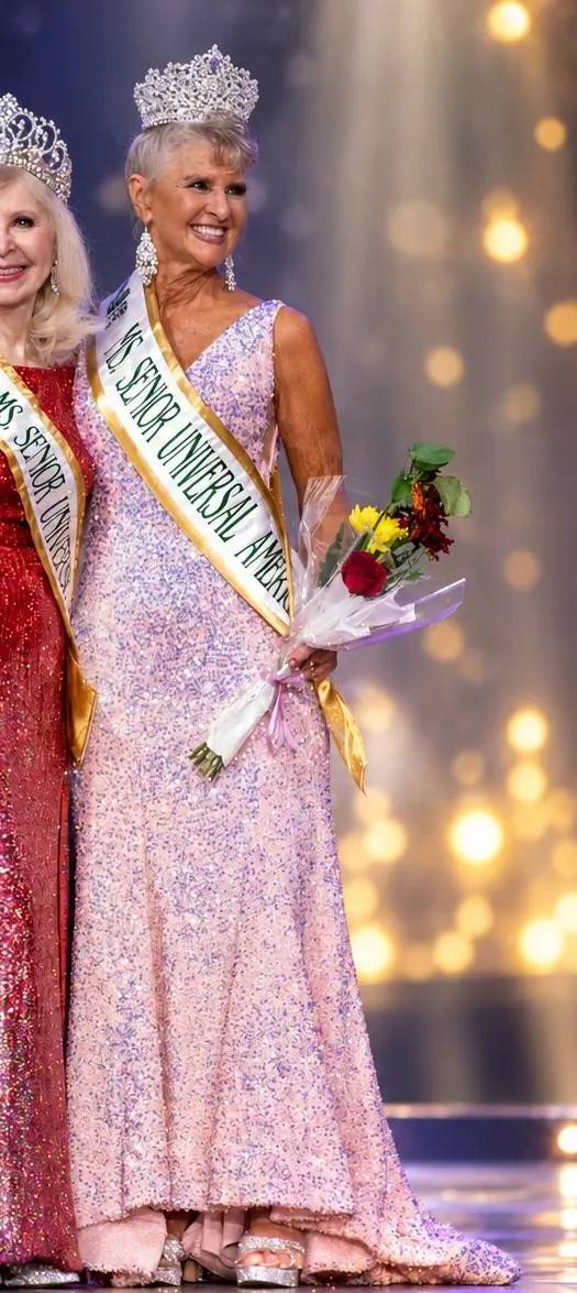 A Ms Senior Universal America titleholder in a pink sequinned gown, holding flowers